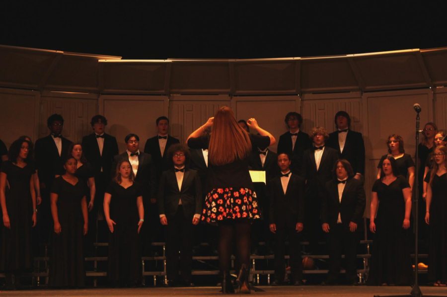 Choral Director Leah Galbraith leads the Chamber choir as they perform The Moon is Distant From the Sea.