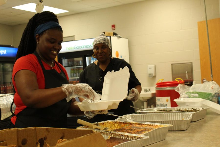 The workers from Rays Wings and Things preparing the meals. Photo By: Bowie Chappee