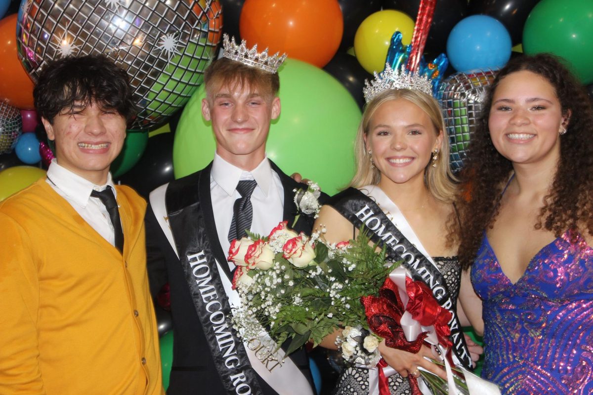 (From left to right) Seniors Julian Brady, Elek Steiner, Callie Mossman, and Marissa Lewis pose at the Homecoming dance. Photo by Sophie Doering