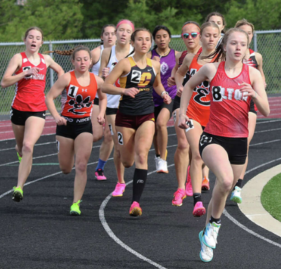 Chloe Miller (front) leads the first lap of the 800 meter at the Triad Invitational in Troy.