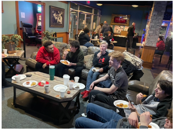 Boys bowling socialize while eating at the senior dinner Photo.