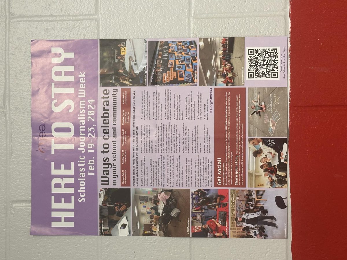 A poster informing people about Scholastic Journalism Week outside of B136.