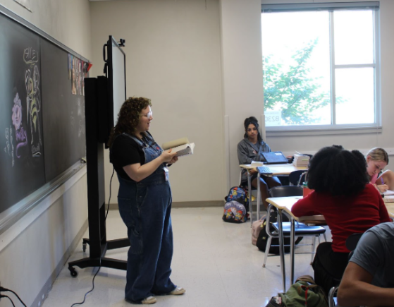 Allyson Moulton analyzes a book with her third hour English class.